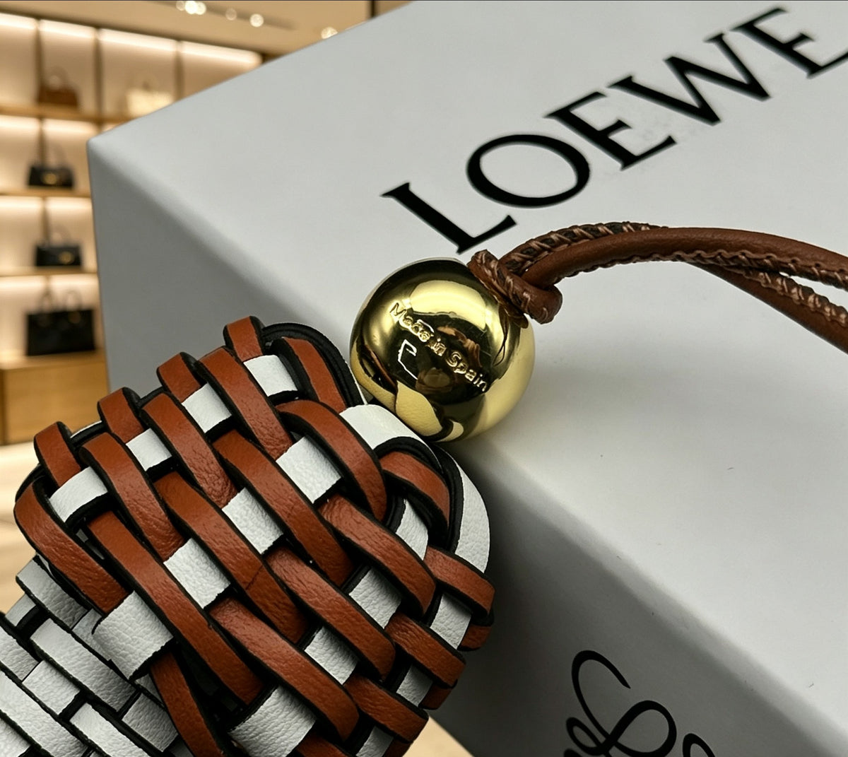 Graphic Emblem Bag Charm in Polished Metal-Tone with Leather Detail – Design 01 close-up detail