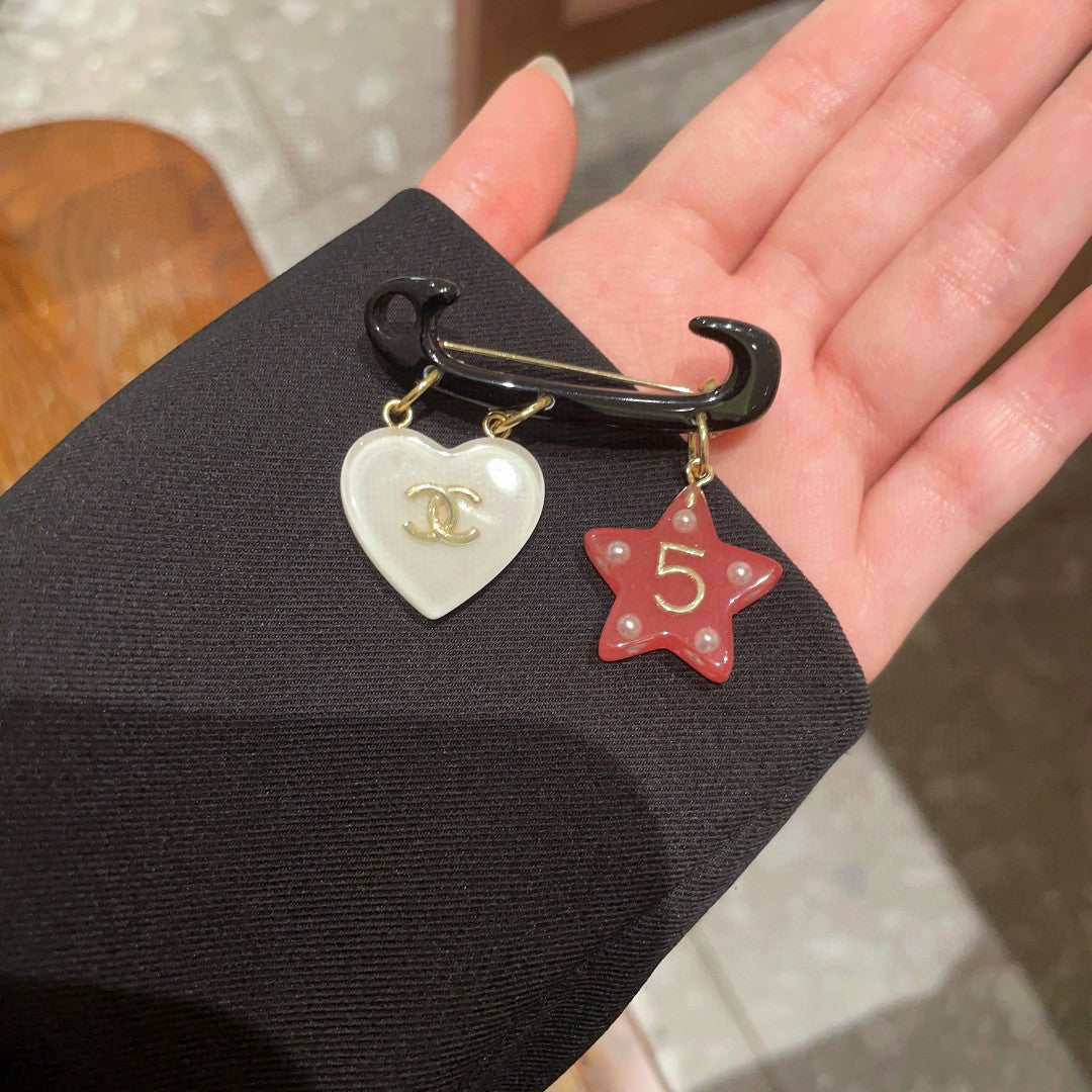 Double-C Emblem Brooch in Polished Metal-Tone – Star Detail detail view