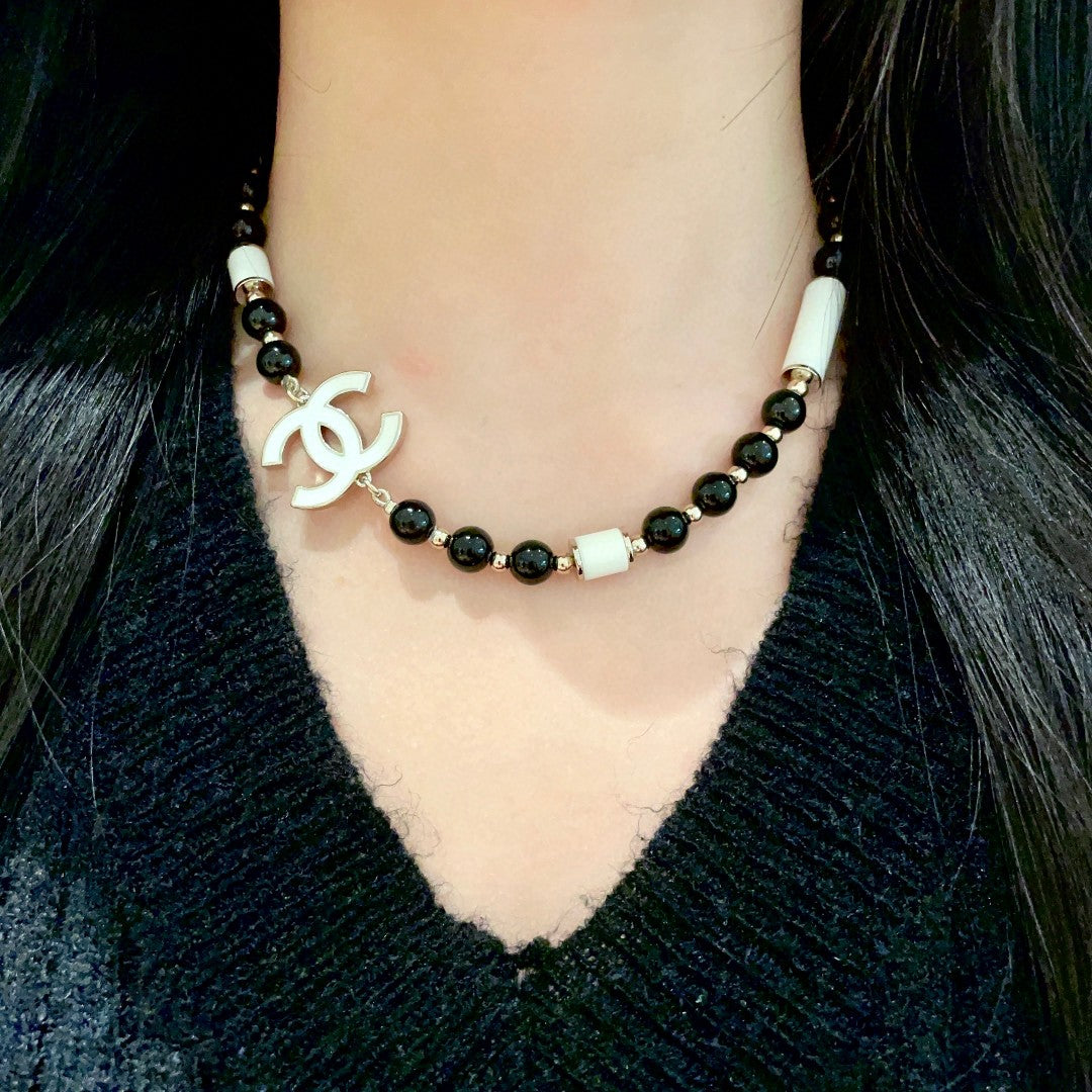 Double-C Emblem Pendant Necklace in Polished Metal-Tone – Black Detail detail view