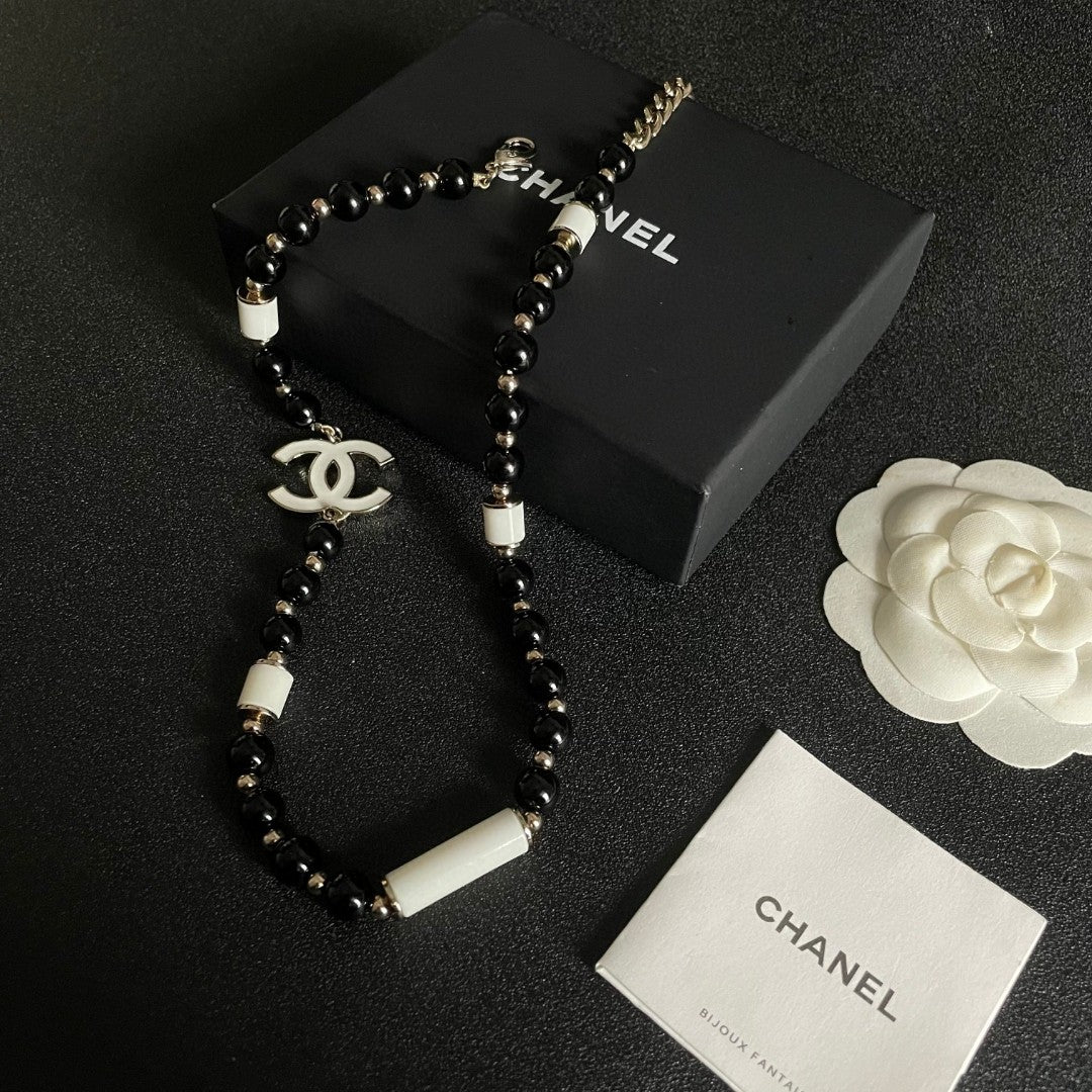 Double-C Emblem Pendant Necklace in Polished Metal-Tone – Black Detail close-up detail