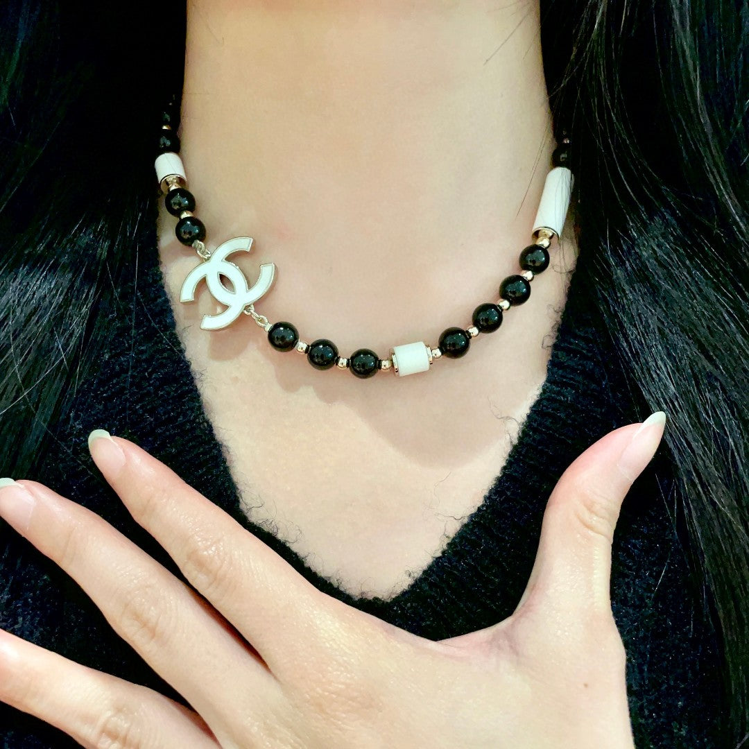Double-C Emblem Pendant Necklace in Polished Metal-Tone – Black Detail front product view