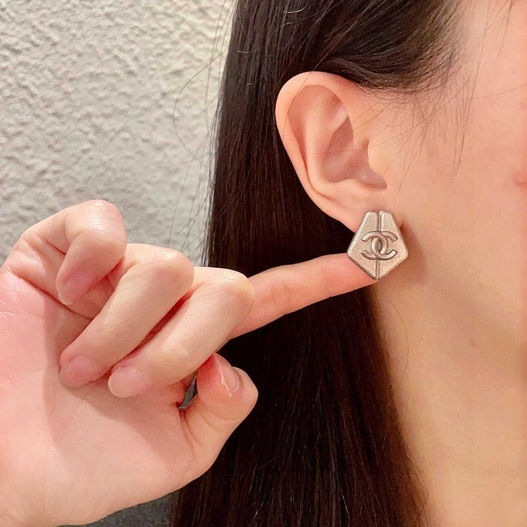 Double-C Emblem Stud Earrings in Polished Metal-Tone – Design 146 front product view