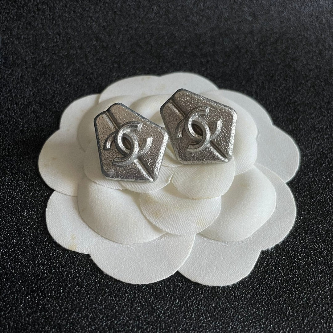 Double-C Emblem Stud Earrings in Polished Metal-Tone – Design 146 front product view