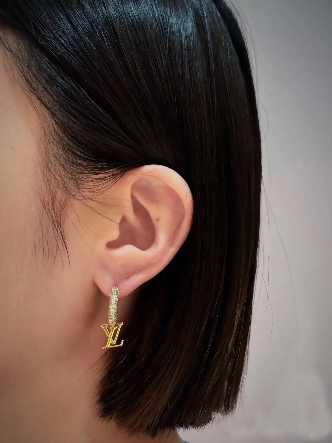 Letter Emblem Statement Earrings in Polished Metal-Tone close-up detail
