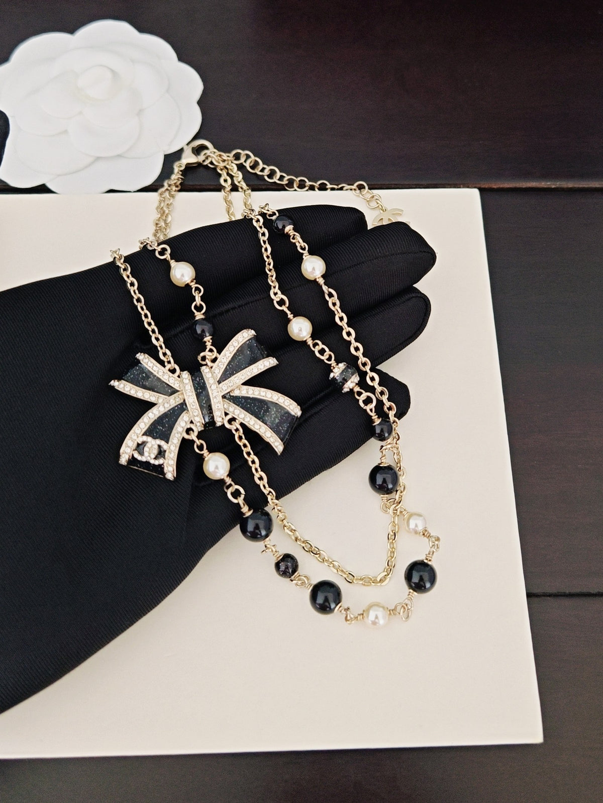 Bow Pendant Necklace in Gold-Tone – Black Detail main product view