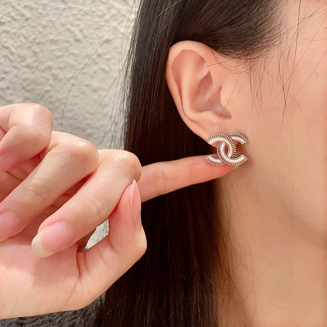 Double-C Emblem Stud Earrings in Polished Metal-Tone – Design 195 front product view