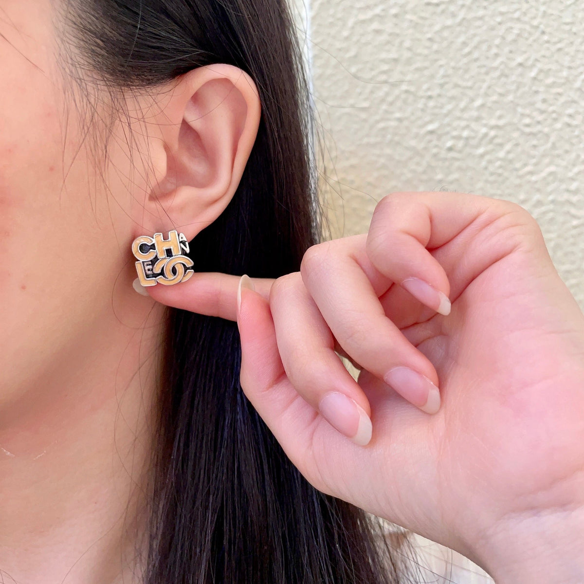Double-C Emblem Stud Earrings in Polished Metal-Tone – Design 212 front product view
