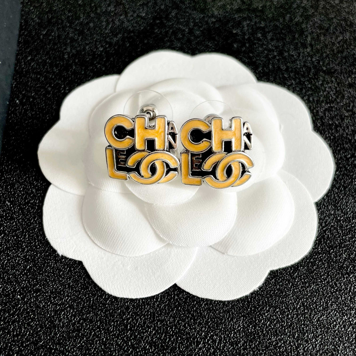 Double-C Emblem Stud Earrings in Polished Metal-Tone – Design 212 front product view