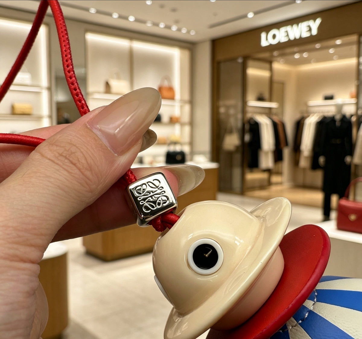 Graphic Emblem Bag Charm in Polished Metal-Tone with Leather Detail – Design 04 side detail