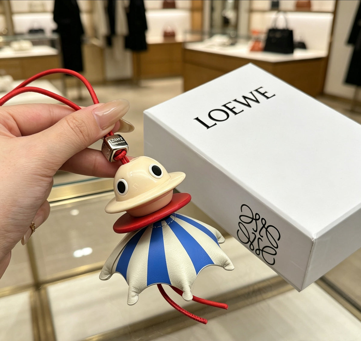 Graphic Emblem Bag Charm in Polished Metal-Tone with Leather Detail – Design 04 front view