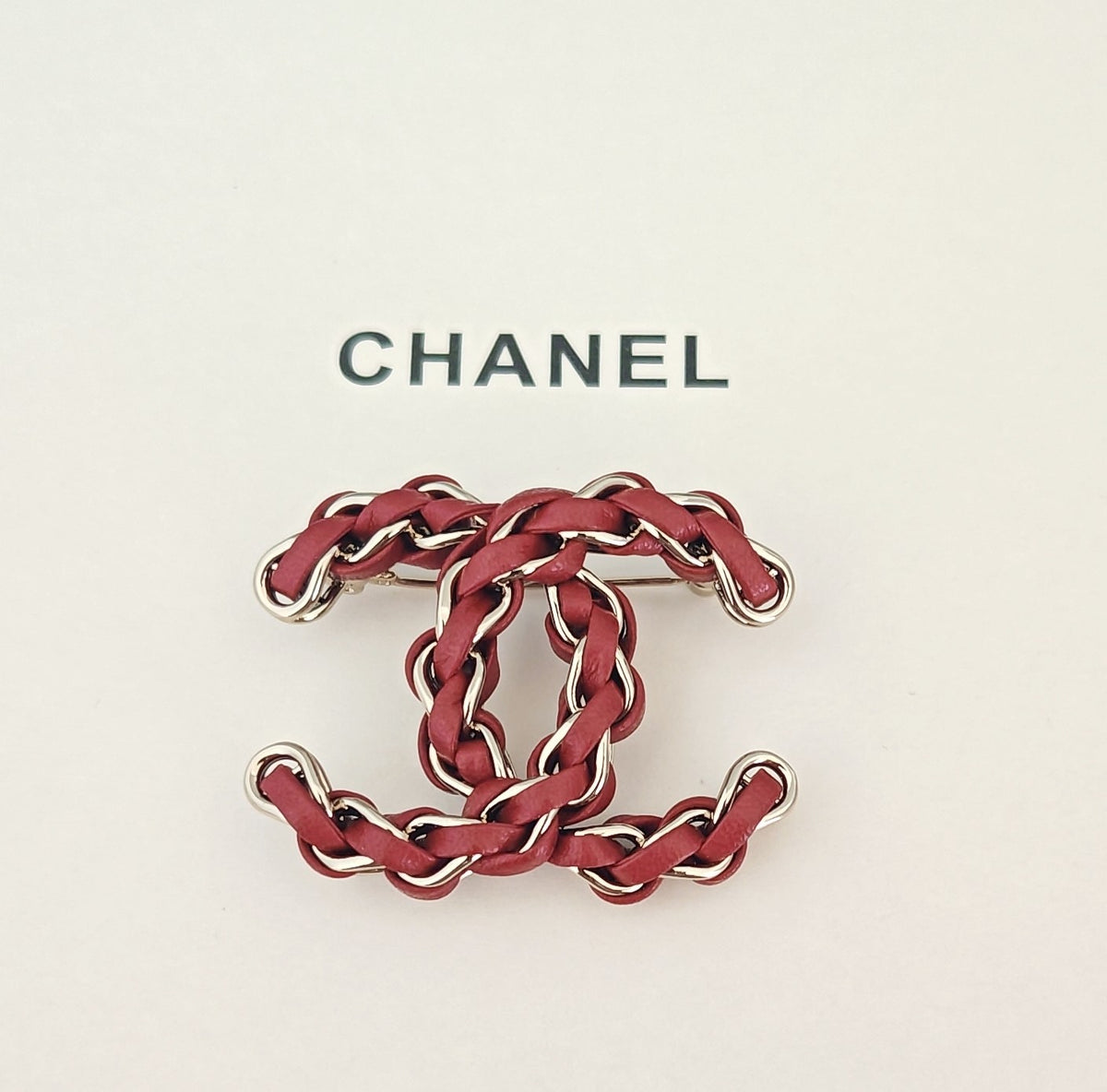 Signature Emblem Brooch in Gold-Tone – Red Detail close-up detail