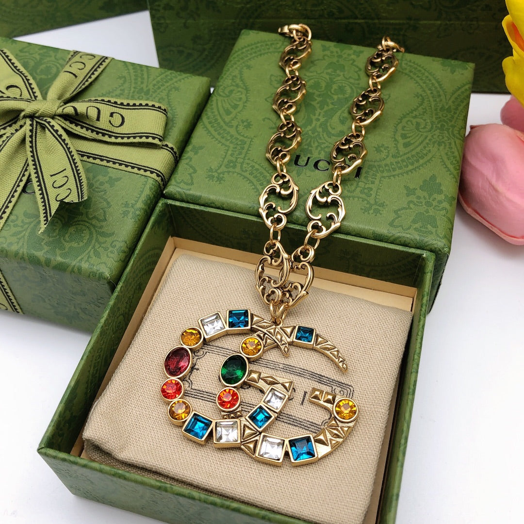Double-G Emblem Pendant Necklace in Polished Metal-Tone – Crystal Detail front product view
