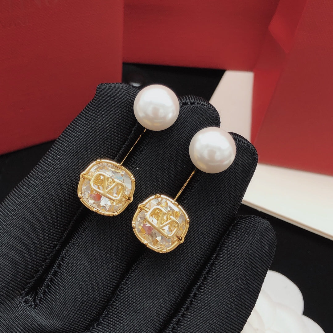 Signature Emblem Pearl-Detail Drop Earrings – White close-up view