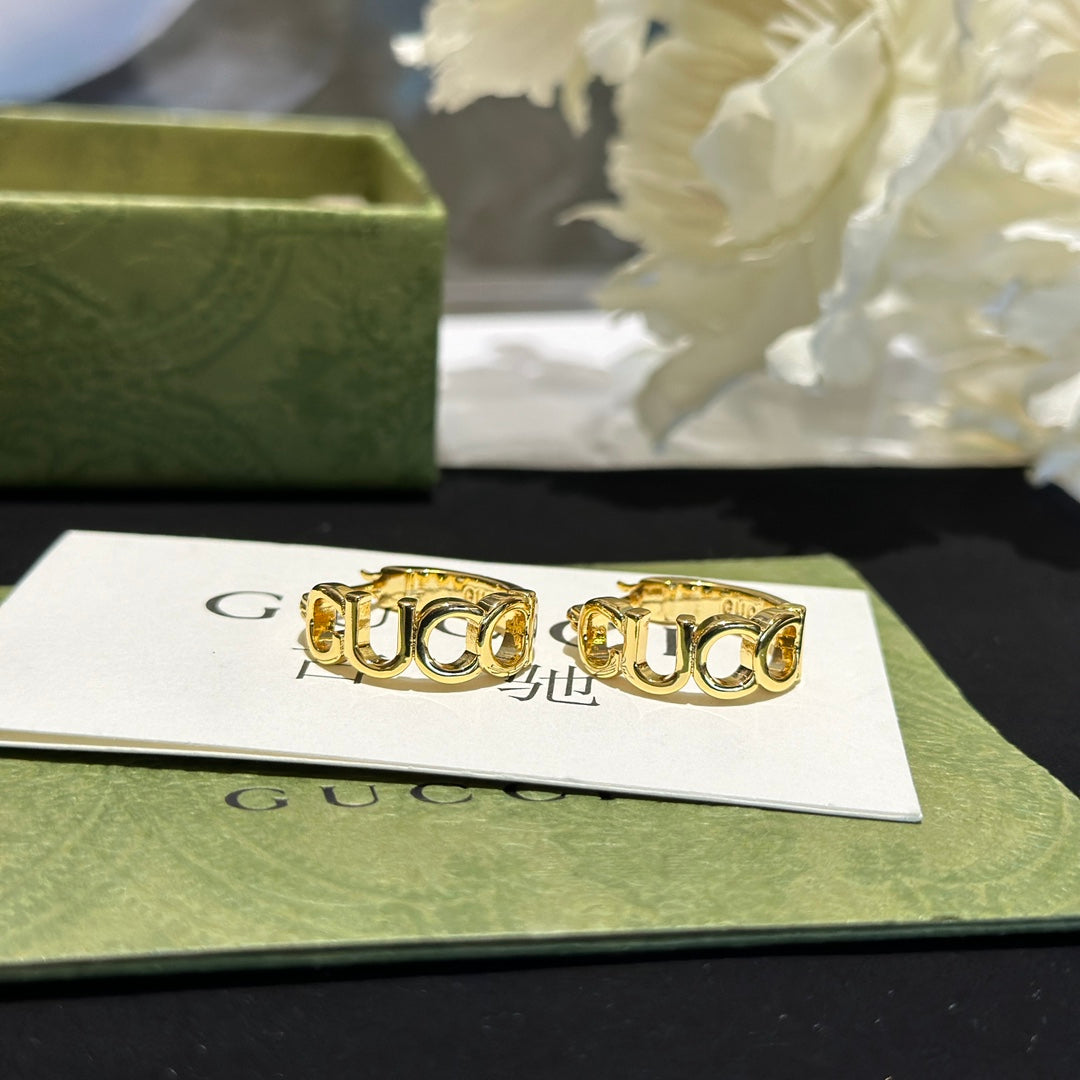 Letter Emblem Statement Earrings in Polished Metal-Tone close-up detail