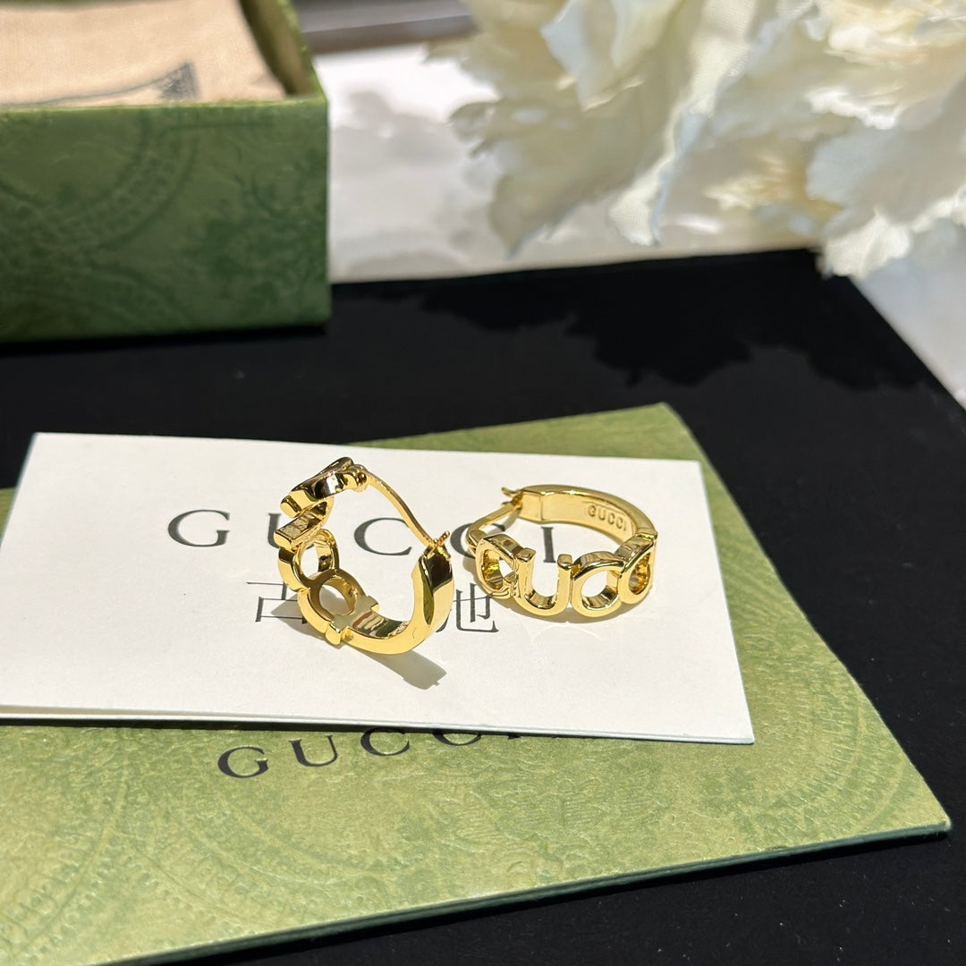 Letter Emblem Statement Earrings in Polished Metal-Tone styled product view