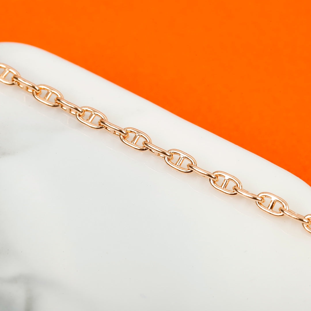 Signature Emblem Bangle in Gold-Tone – Red Detail main product view