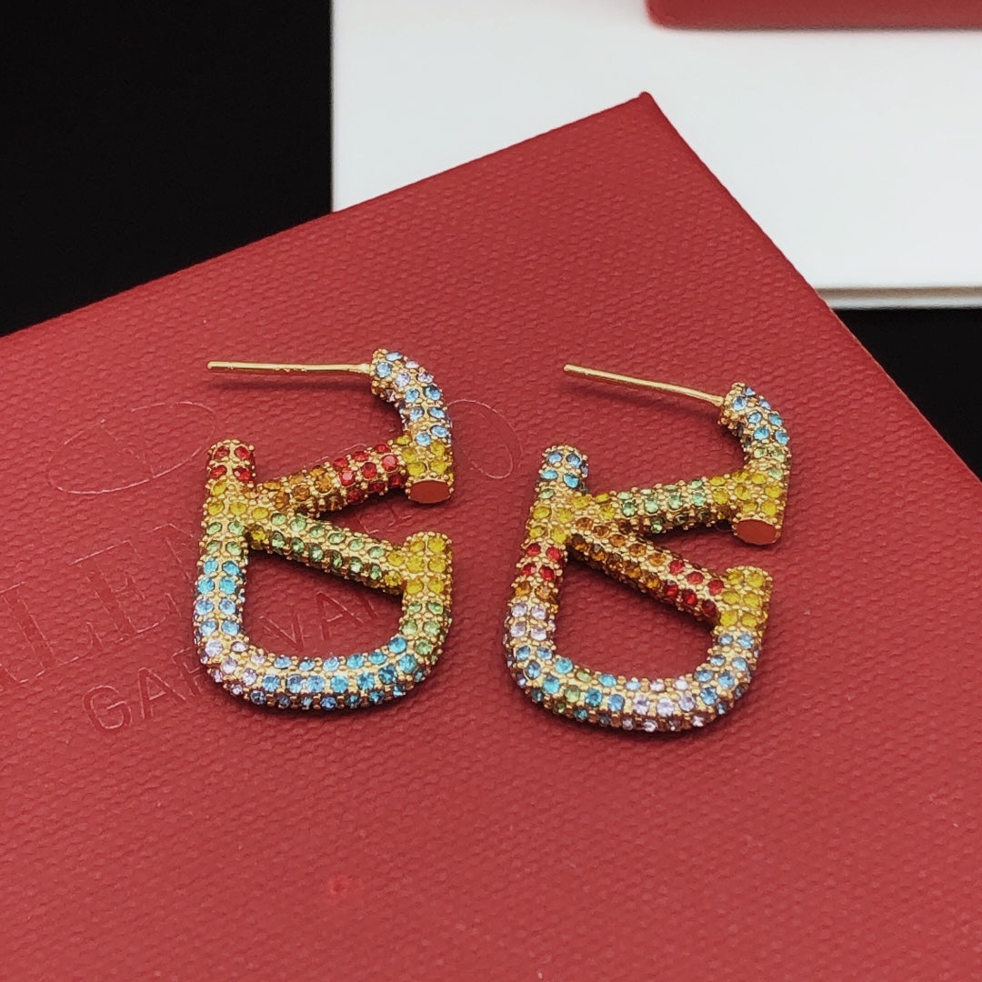 Signature Emblem Crystal-Accent Stud Earrings – Medium close-up view