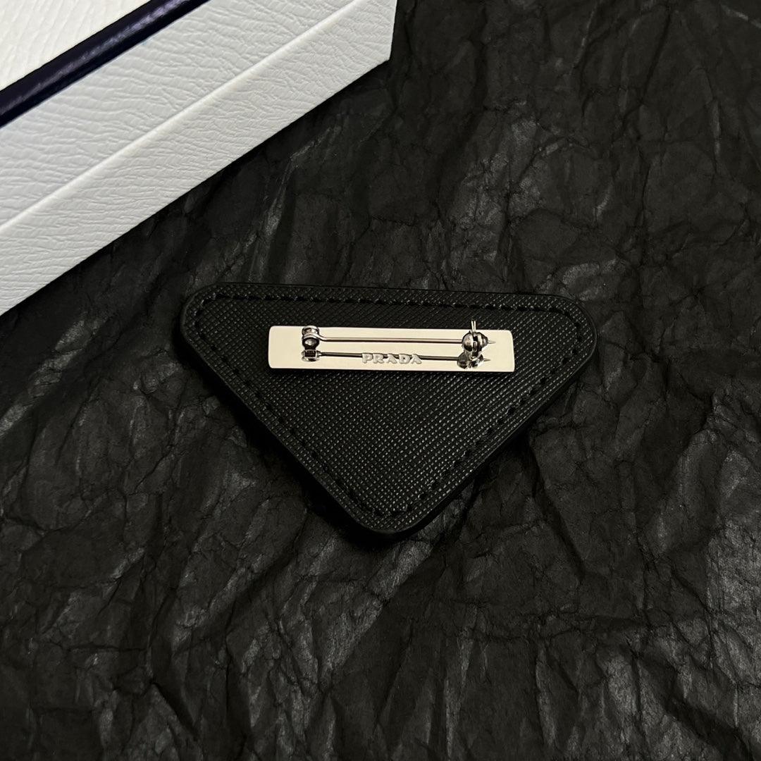 Signature Emblem Brooch in Polished Metal-Tone detail view