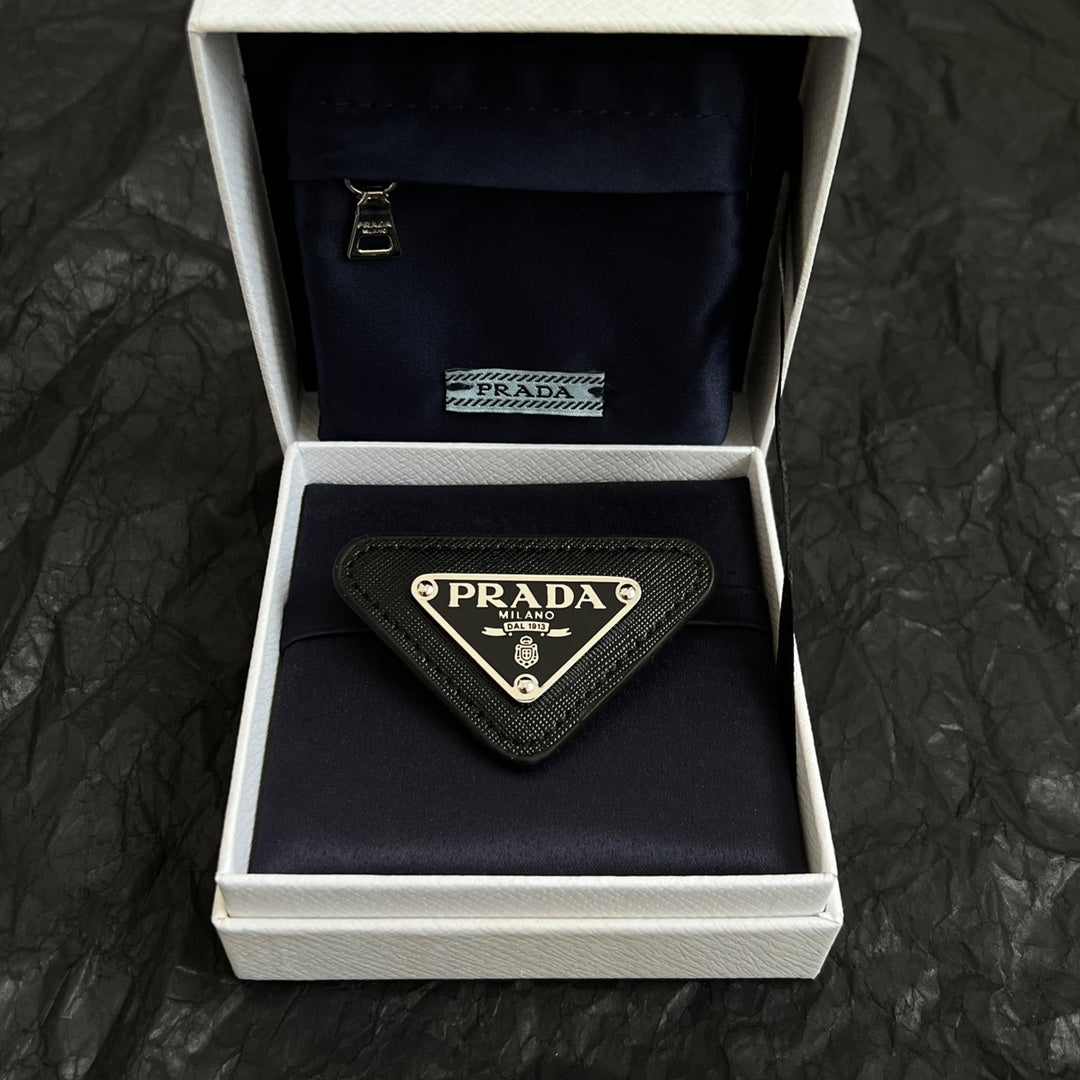 Signature Emblem Brooch in Polished Metal-Tone close-up view