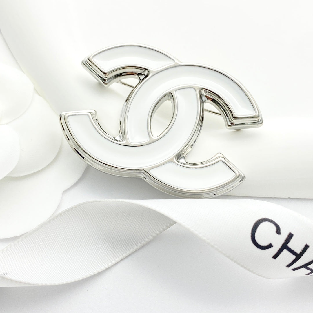 Double-C Emblem Brooch in Polished Metal-Tone – White Detail close-up detail