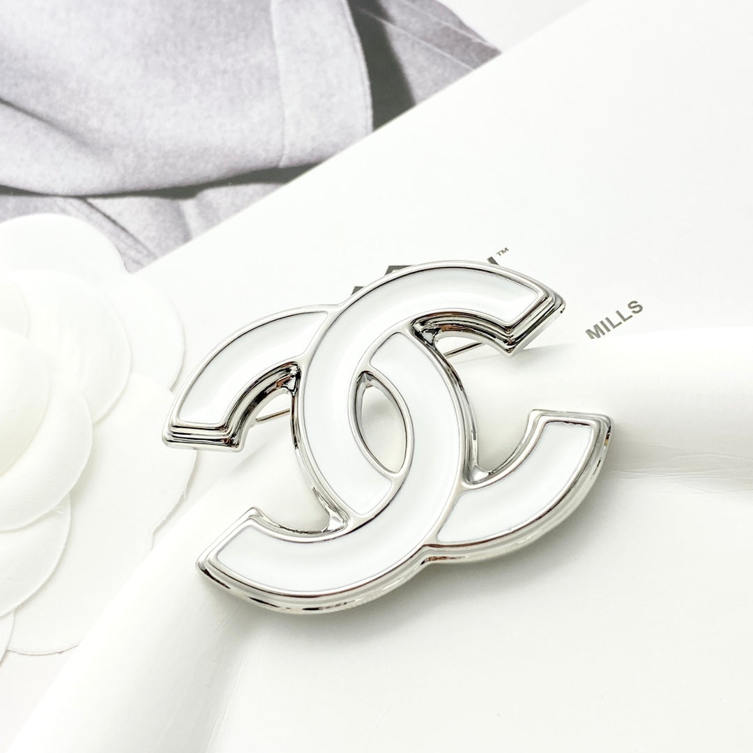 Double-C Emblem Brooch in Polished Metal-Tone – White Detail main product view