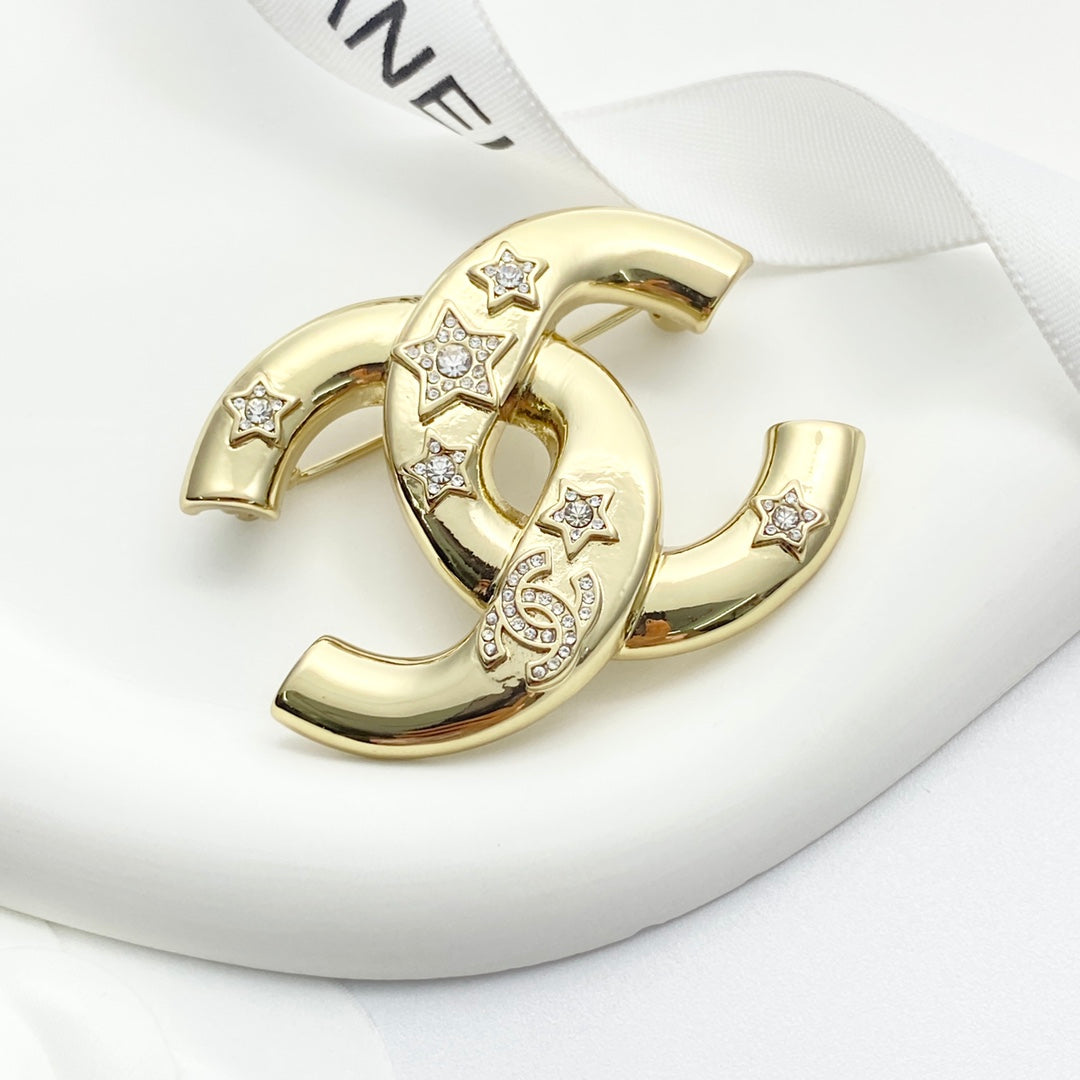 Double-C Emblem Brooch in Gold-Tone – Star Detail close-up detail