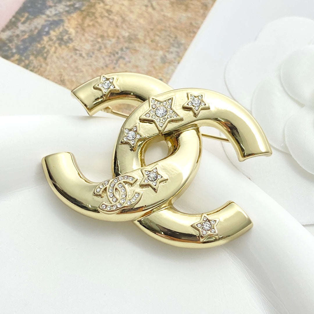 Double-C Emblem Brooch in Gold-Tone – Star Detail detail view