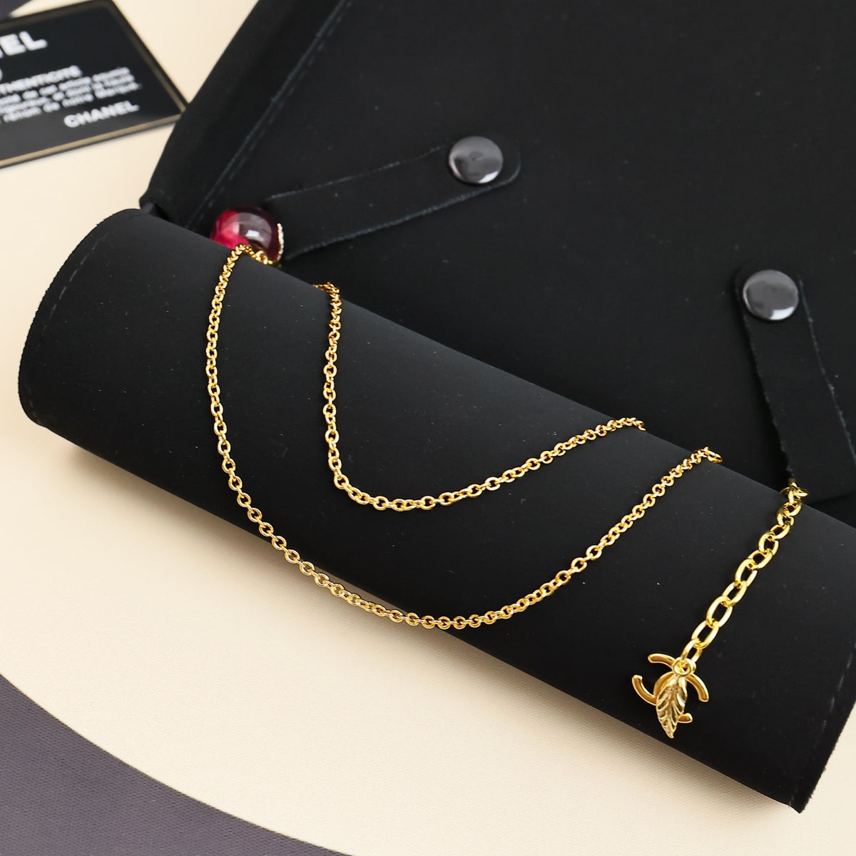 Signature Emblem Pendant Necklace in Polished Metal-Tone – Pink Detail main product view