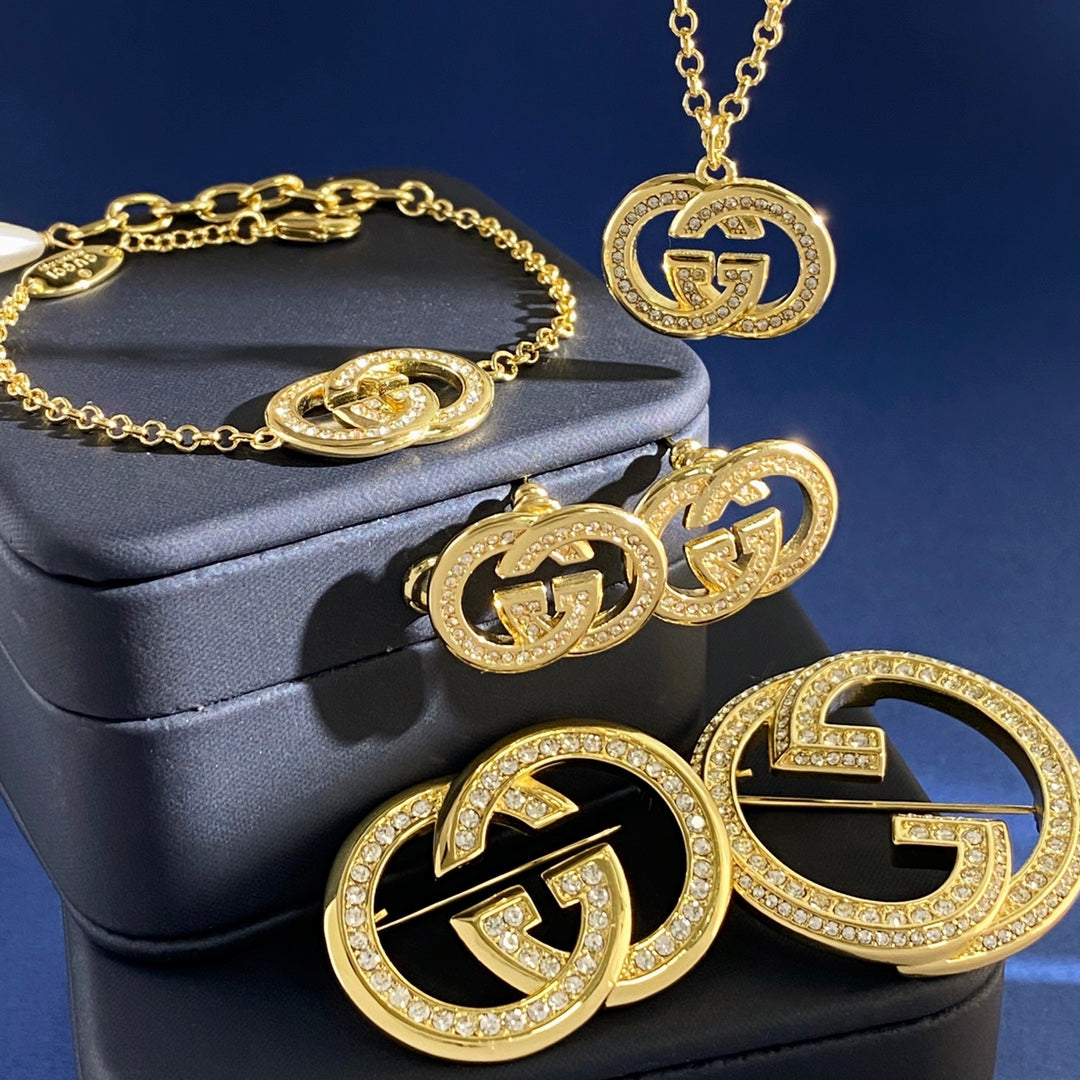 Double-G Emblem Brooch in Gold-Tone – Crystal Detail detail view