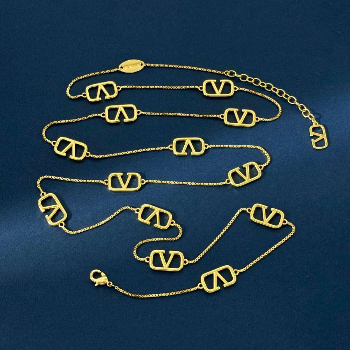 V Emblem Long Pendant Necklace – Design 02 styled detail