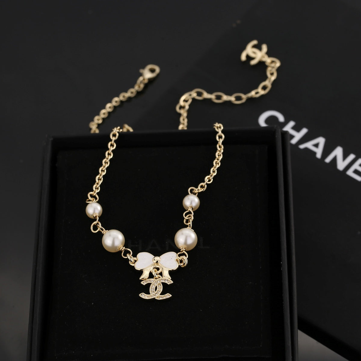 Bow Pendant Necklace in Polished Metal-Tone styled product view