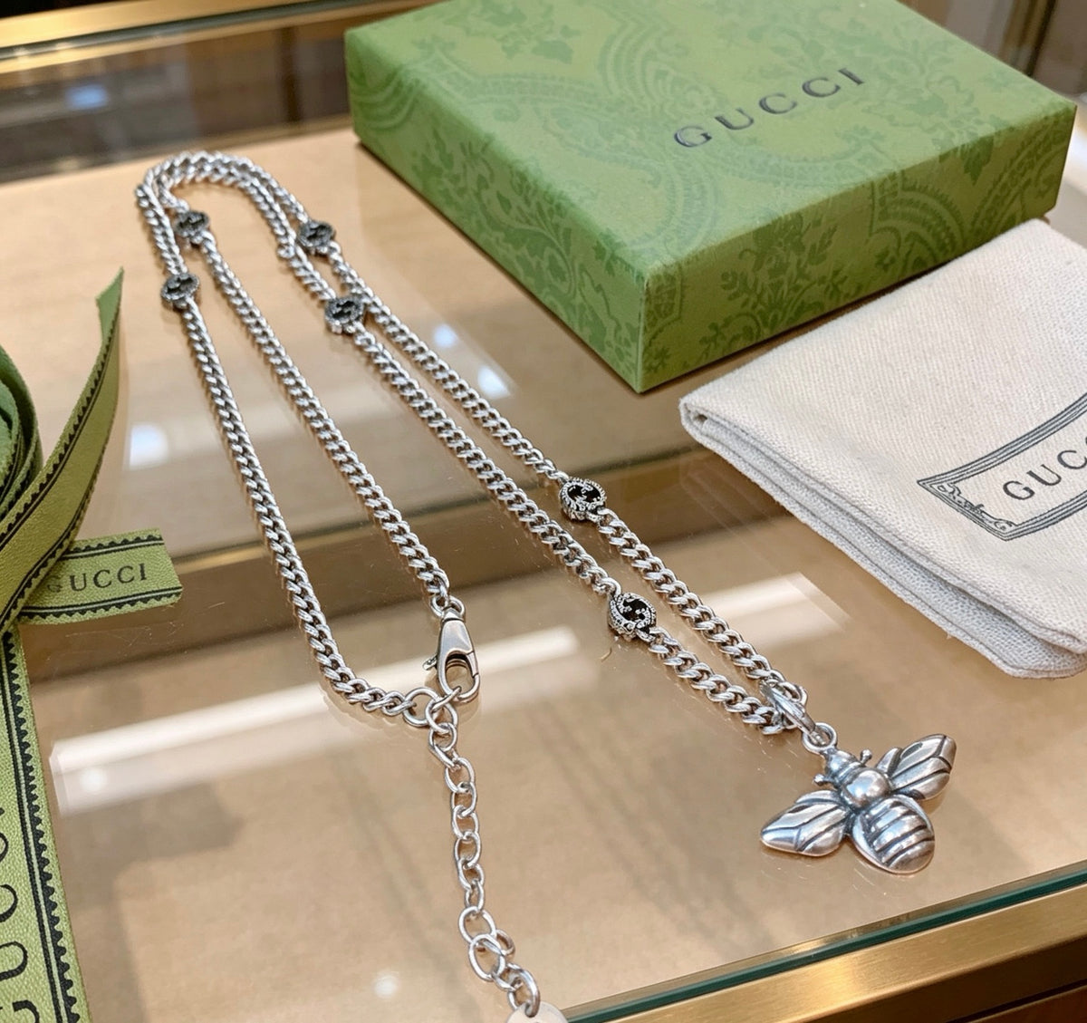 Double-G Emblem Pendant Necklace in Polished Metal-Tone – Bee Detail front product view