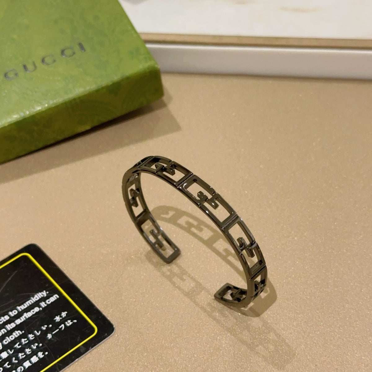 Double-G Emblem Bangle in Polished Metal-Tone – Design 020 close-up detail