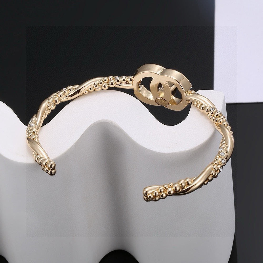 Signature Emblem Bangle in Polished Metal-Tone – Design 028 detail view
