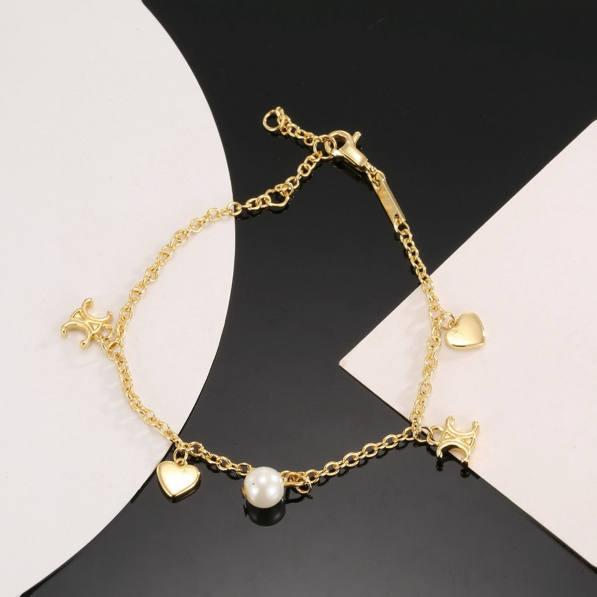 Triomphe-Inspired Emblem Bracelet in Gold-Tone – Red detail view