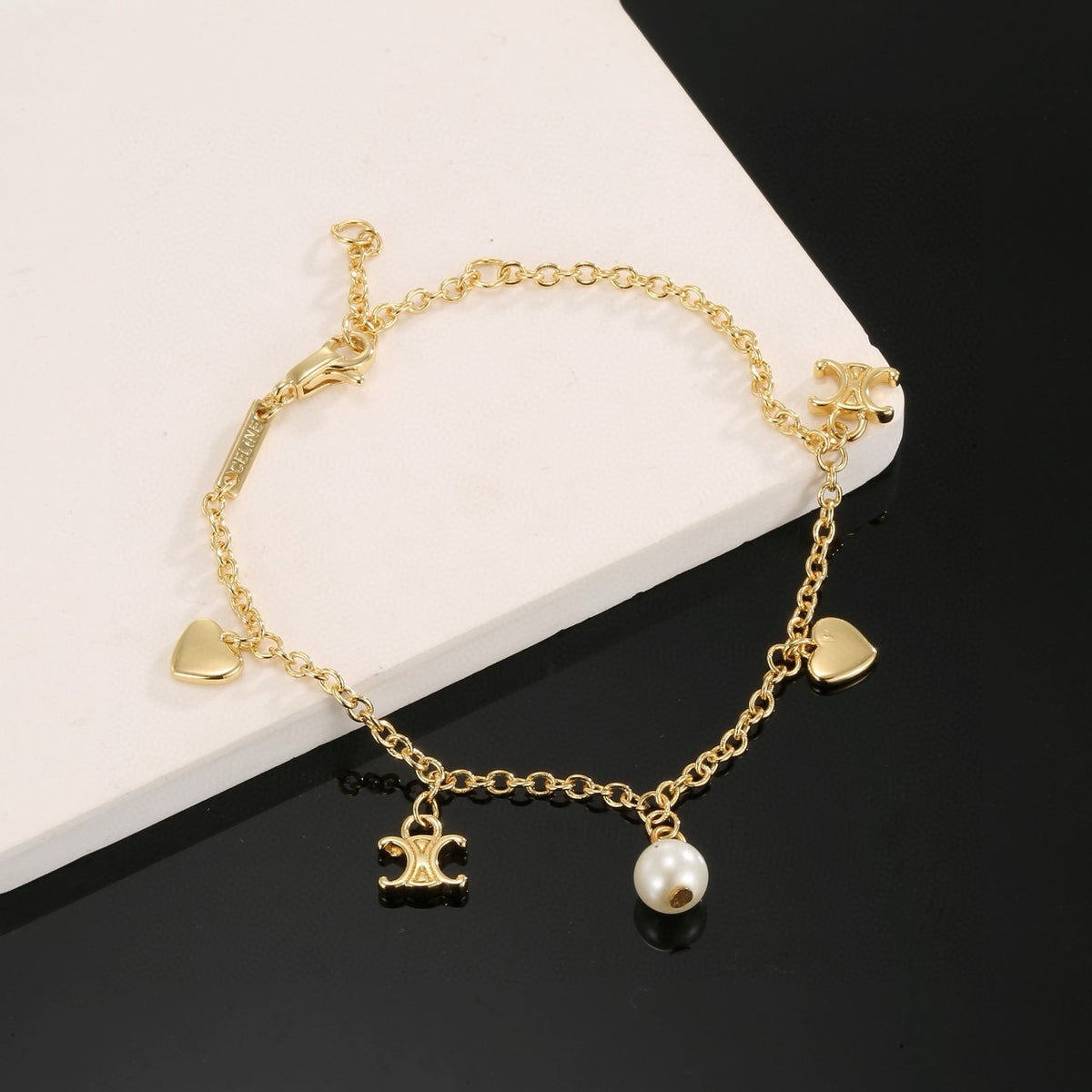 Triomphe-Inspired Emblem Bracelet in Gold-Tone – Red – Design 02 close-up view