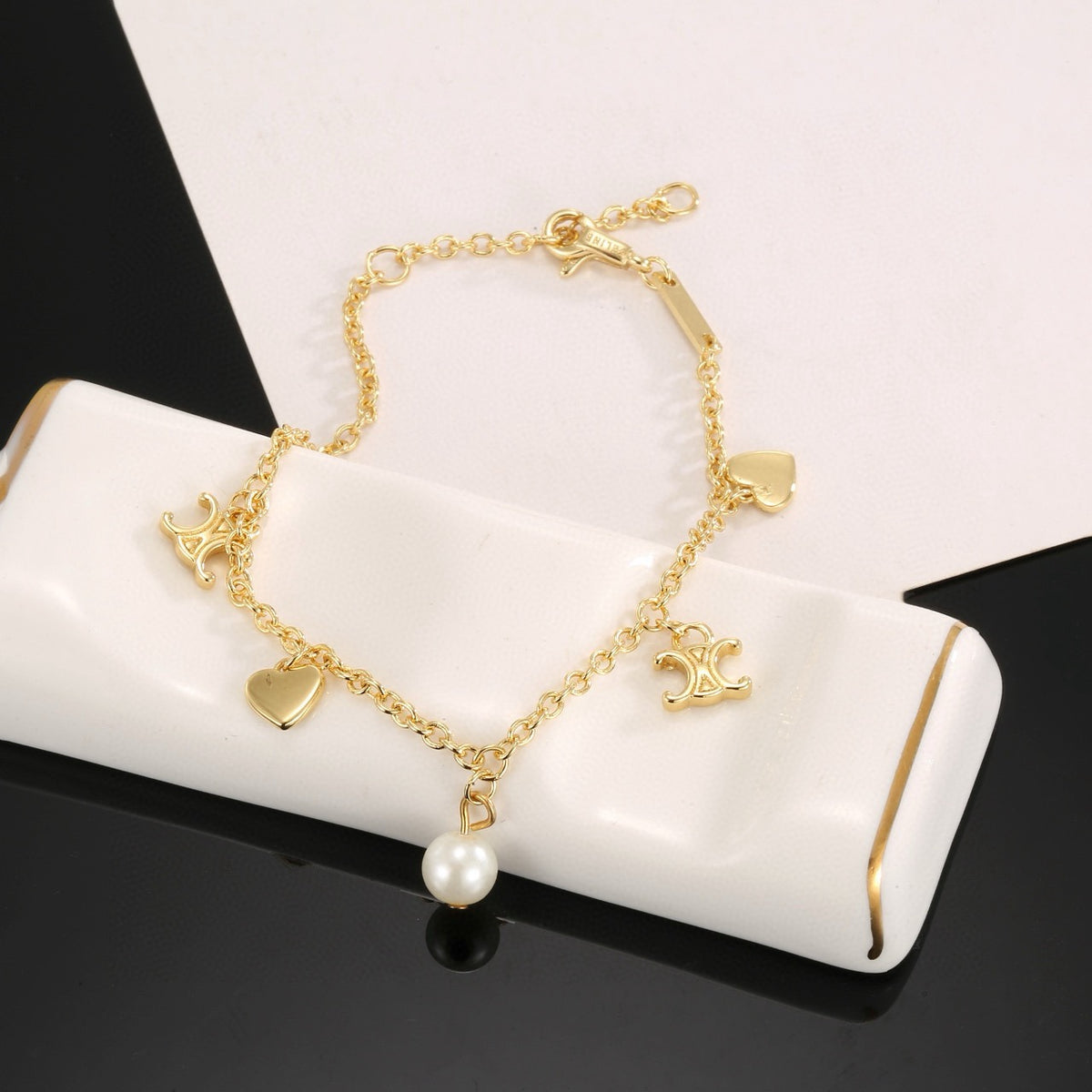 Triomphe-Inspired Emblem Bracelet in Gold-Tone – Red side detail