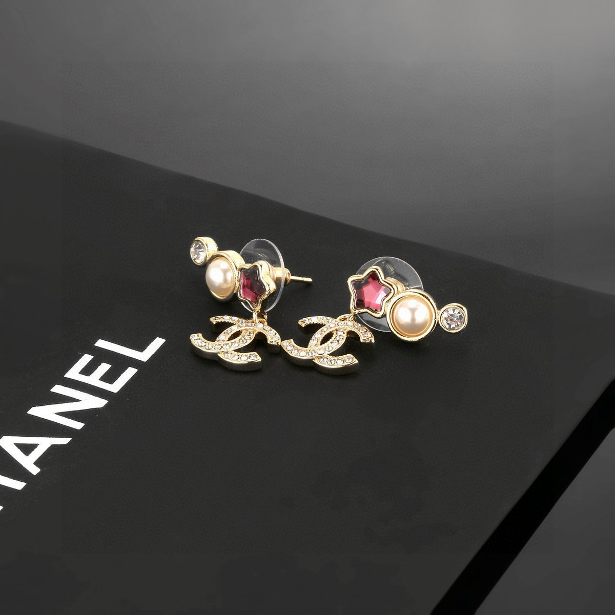 Double-C Emblem Stud Earrings in Gold-Tone – Star Detail – Design 006 detail view