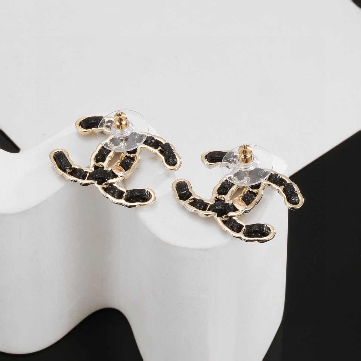 Signature Emblem Stud Earrings in Polished Metal-Tone – Black Detail detail view