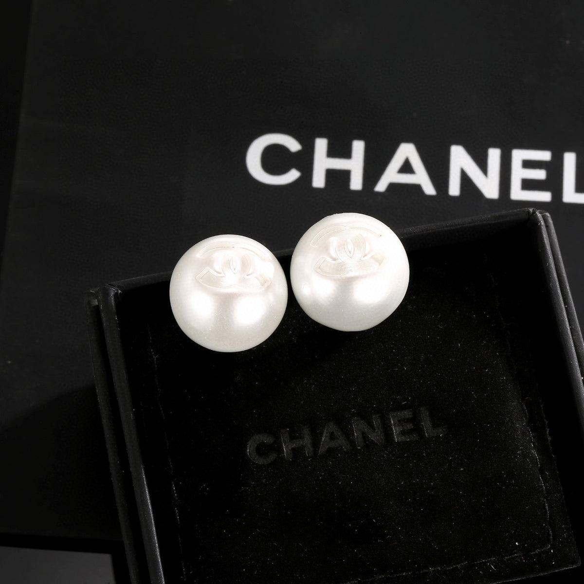 Double-C Emblem Stud Earrings in Polished Metal-Tone – White Detail – Design 003 side detail