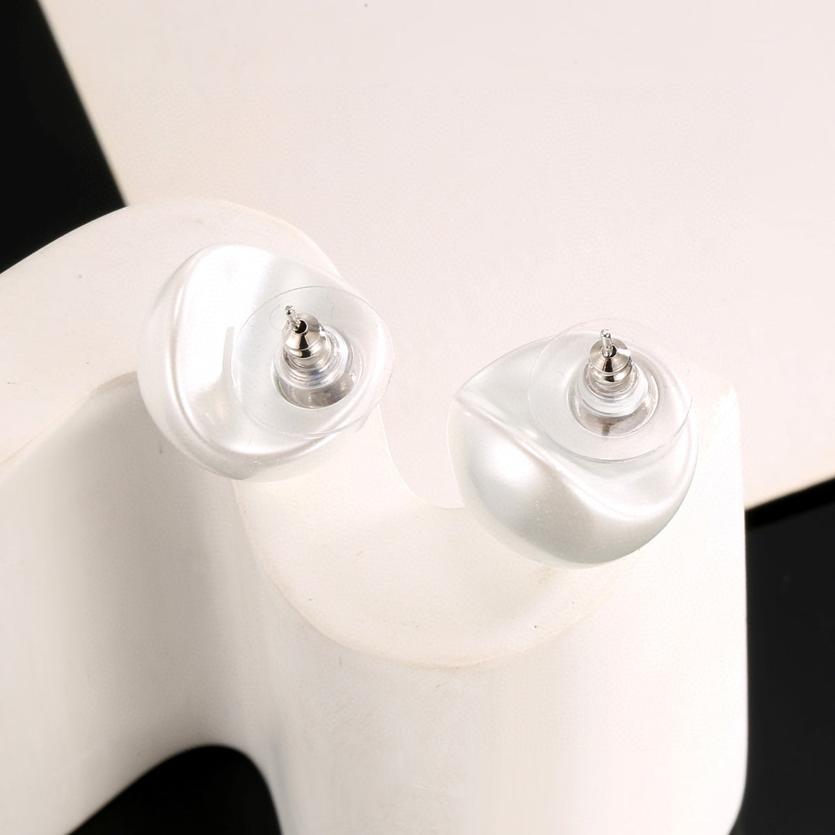 Double-C Emblem Stud Earrings in Polished Metal-Tone – White Detail – Design 003 main product view