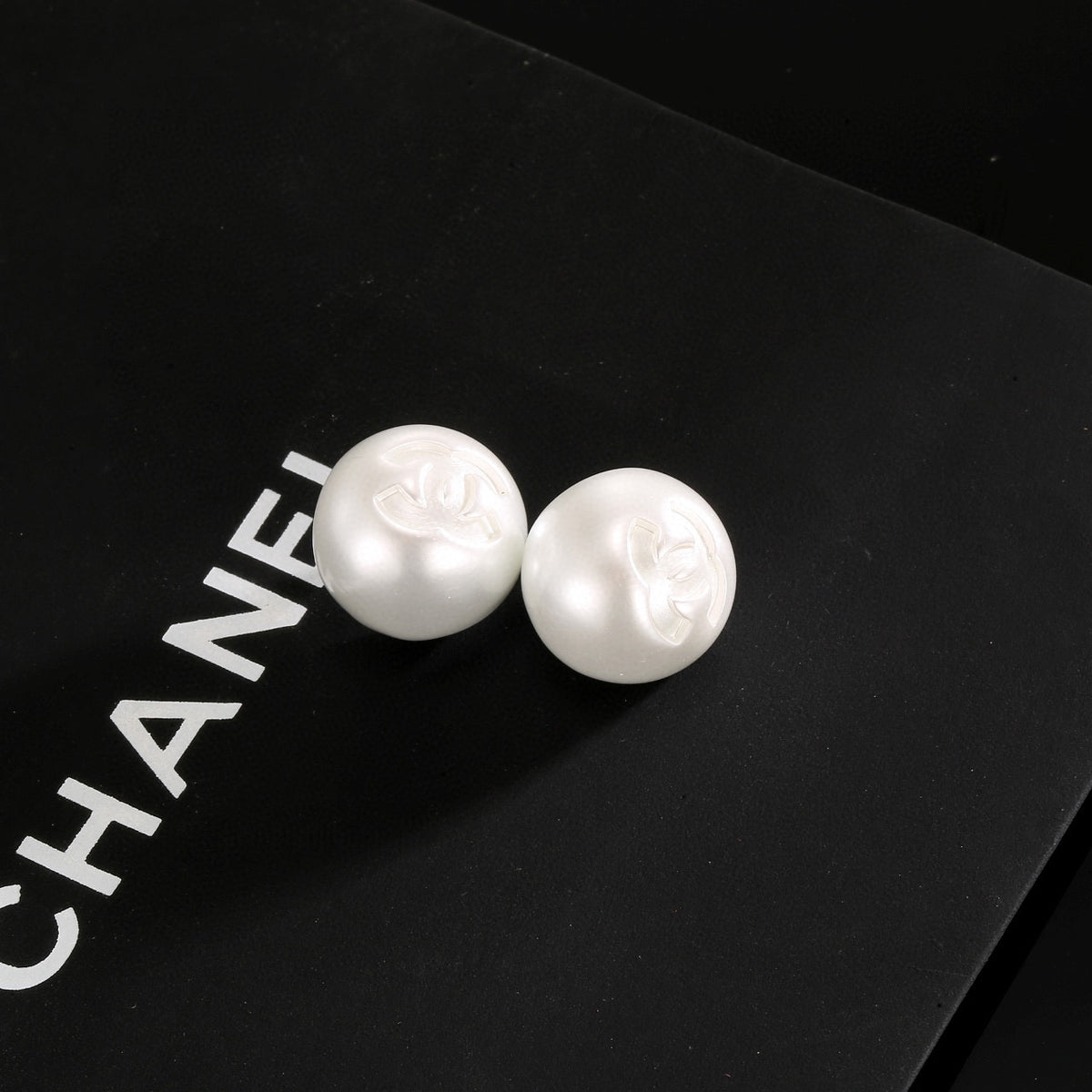 Double-C Emblem Stud Earrings in Polished Metal-Tone – White Detail – Design 003 front product view
