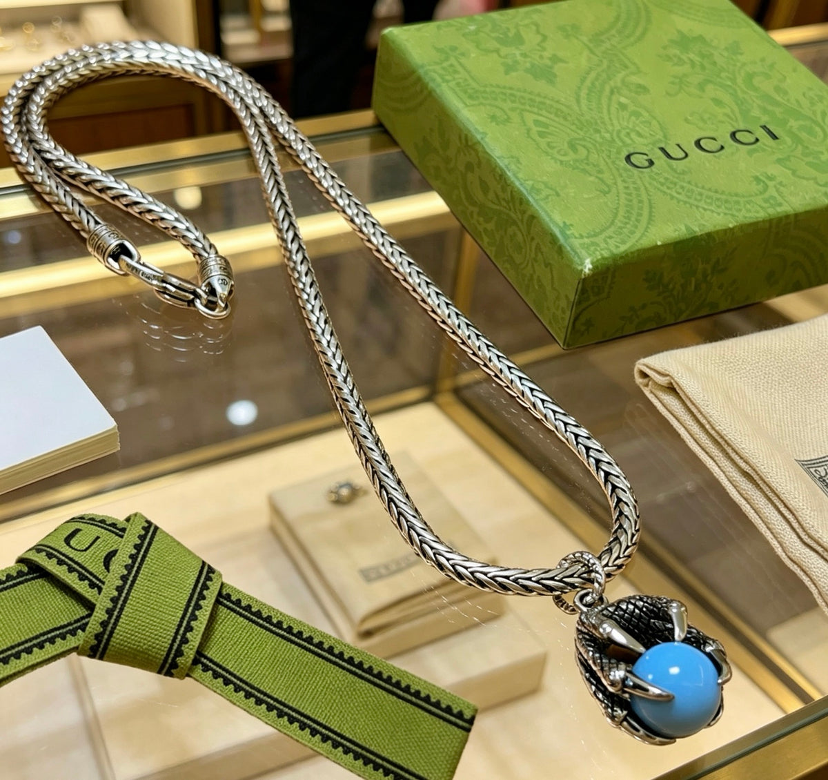 Double-G Emblem Pendant Necklace in Polished Metal-Tone – Turquoise Detail front product view