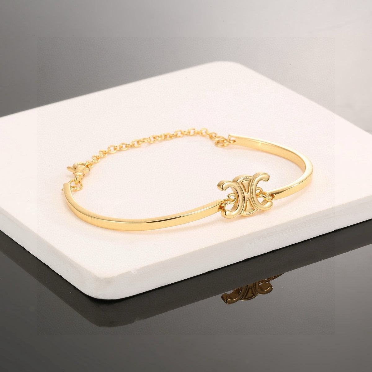 Signature Emblem Bangle in Polished Metal-Tone – Red Detail side detail