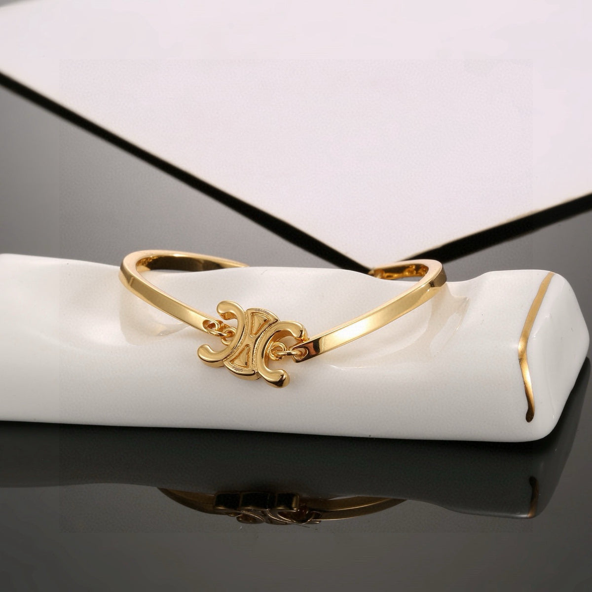 Signature Emblem Bangle in Polished Metal-Tone – Red Detail front product view
