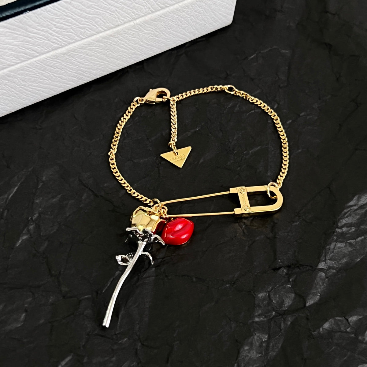 Signature Emblem Bracelet in Polished Metal-Tone close-up view