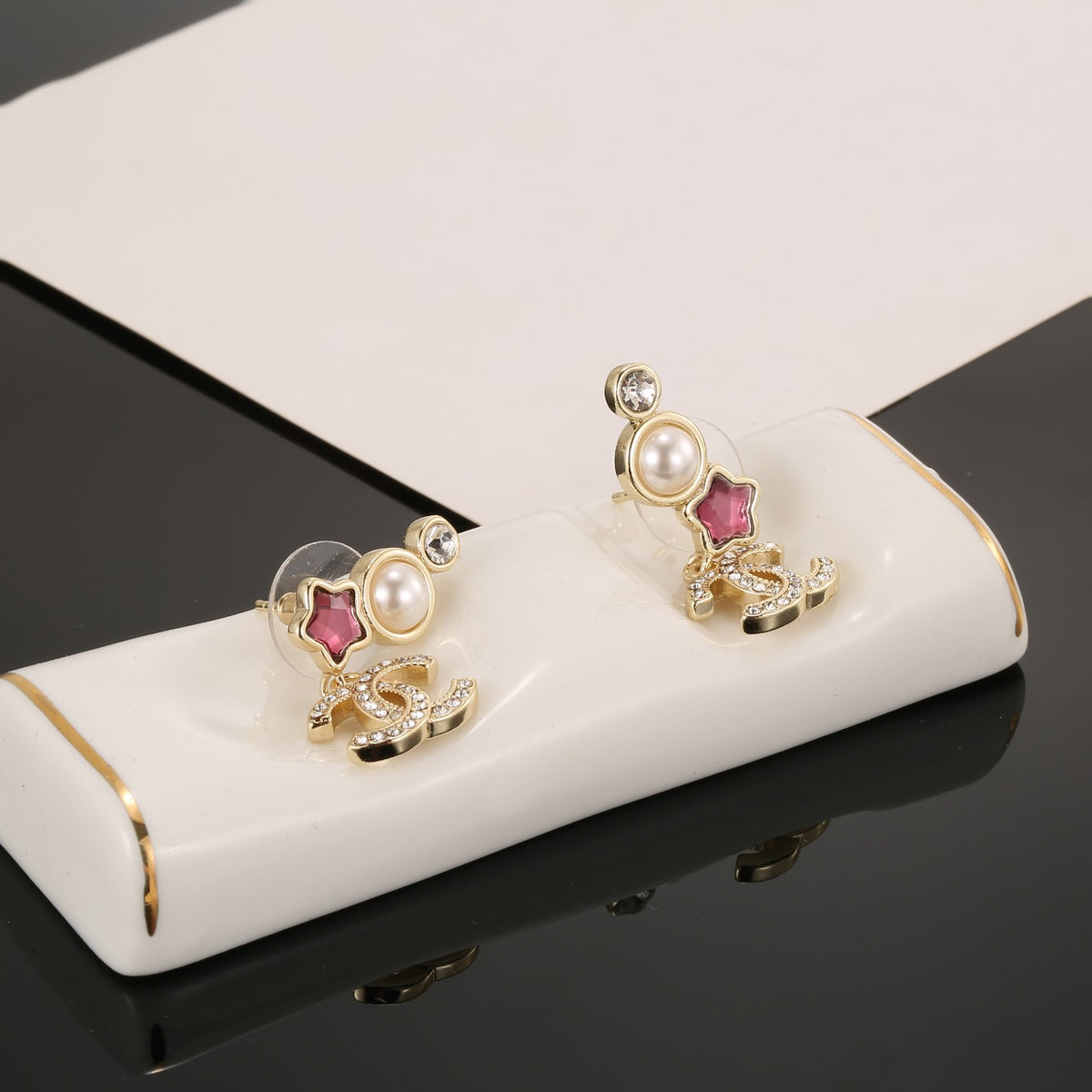 Double-C Emblem Stud Earrings in Gold-Tone – Star Detail – Design 003 detail view