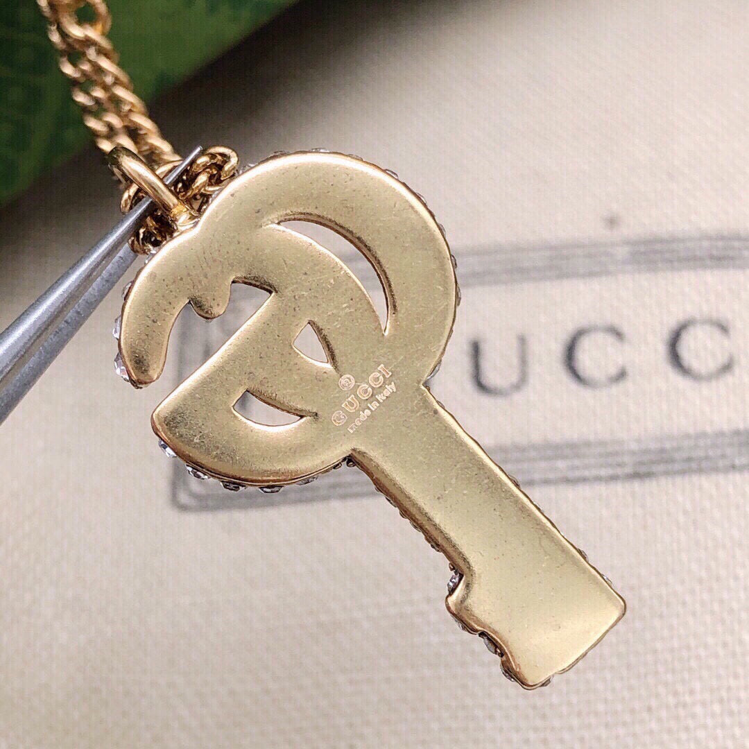 Double-G Emblem Pendant Necklace in Polished Metal-Tone – Crystal Detail – Design 002 close-up detail