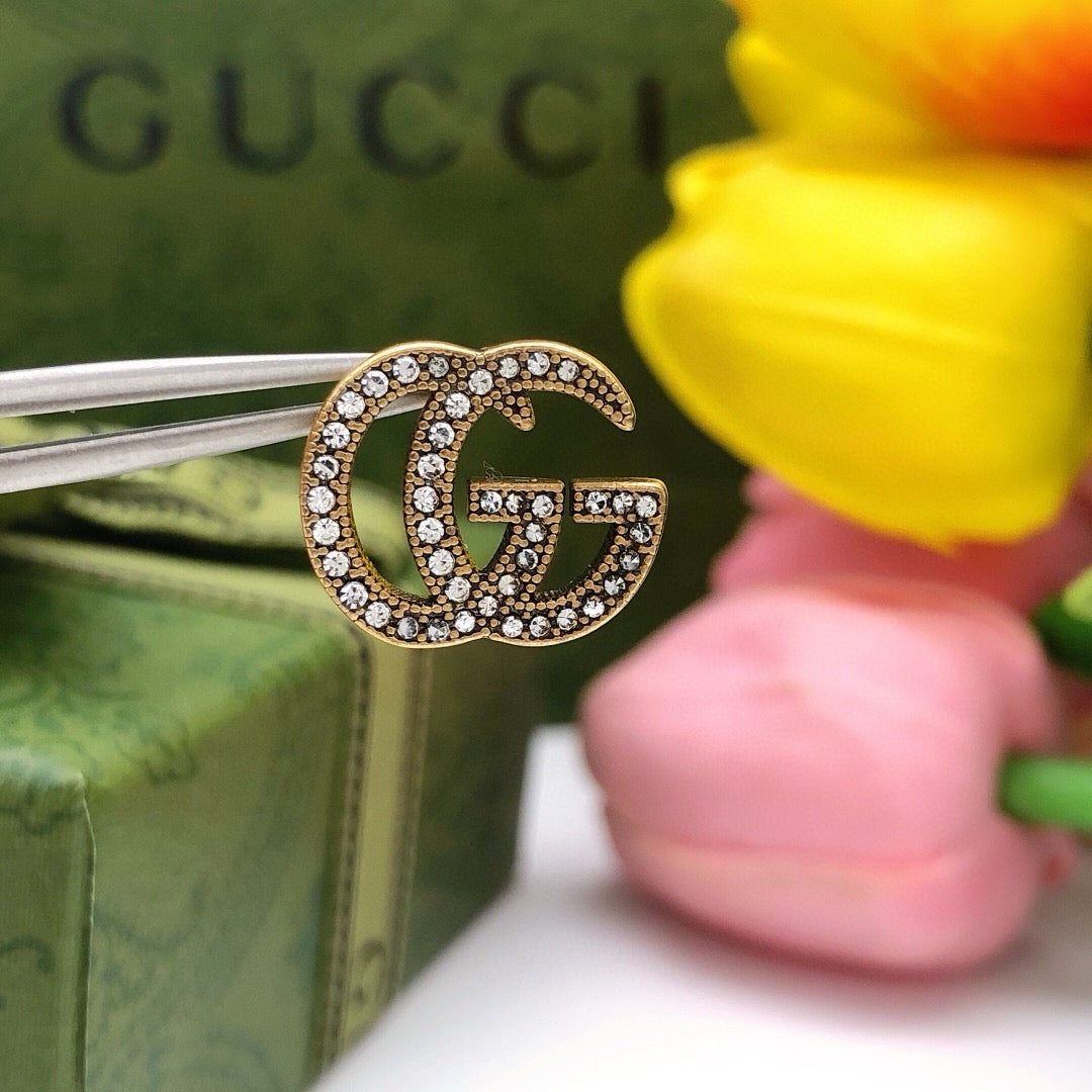 Double-G Emblem Stud Earrings in Polished Metal-Tone – Design 021 detail view