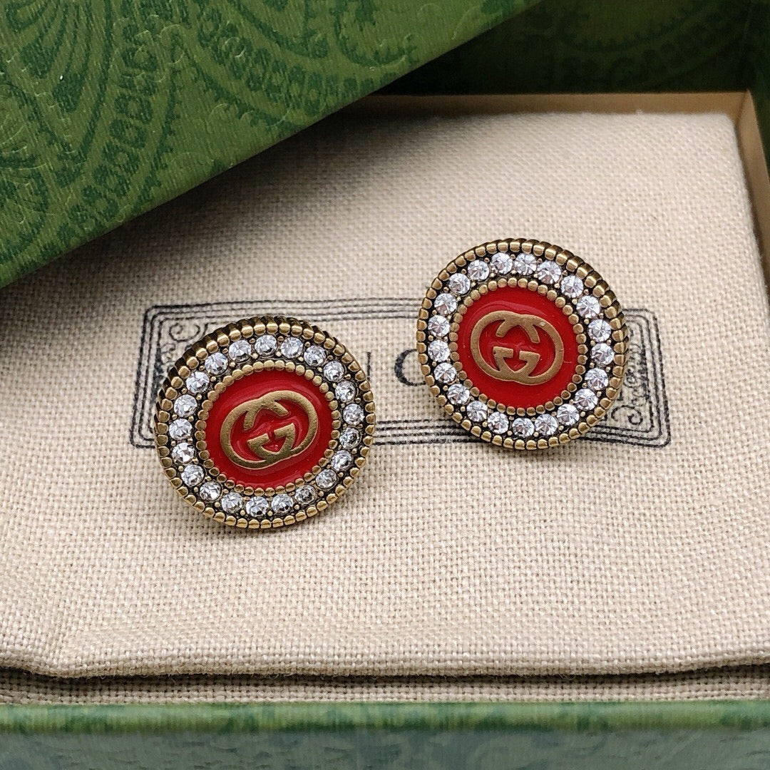 Geometric Emblem Stud Earrings in Polished Metal-Tone – Red Detail close-up detail
